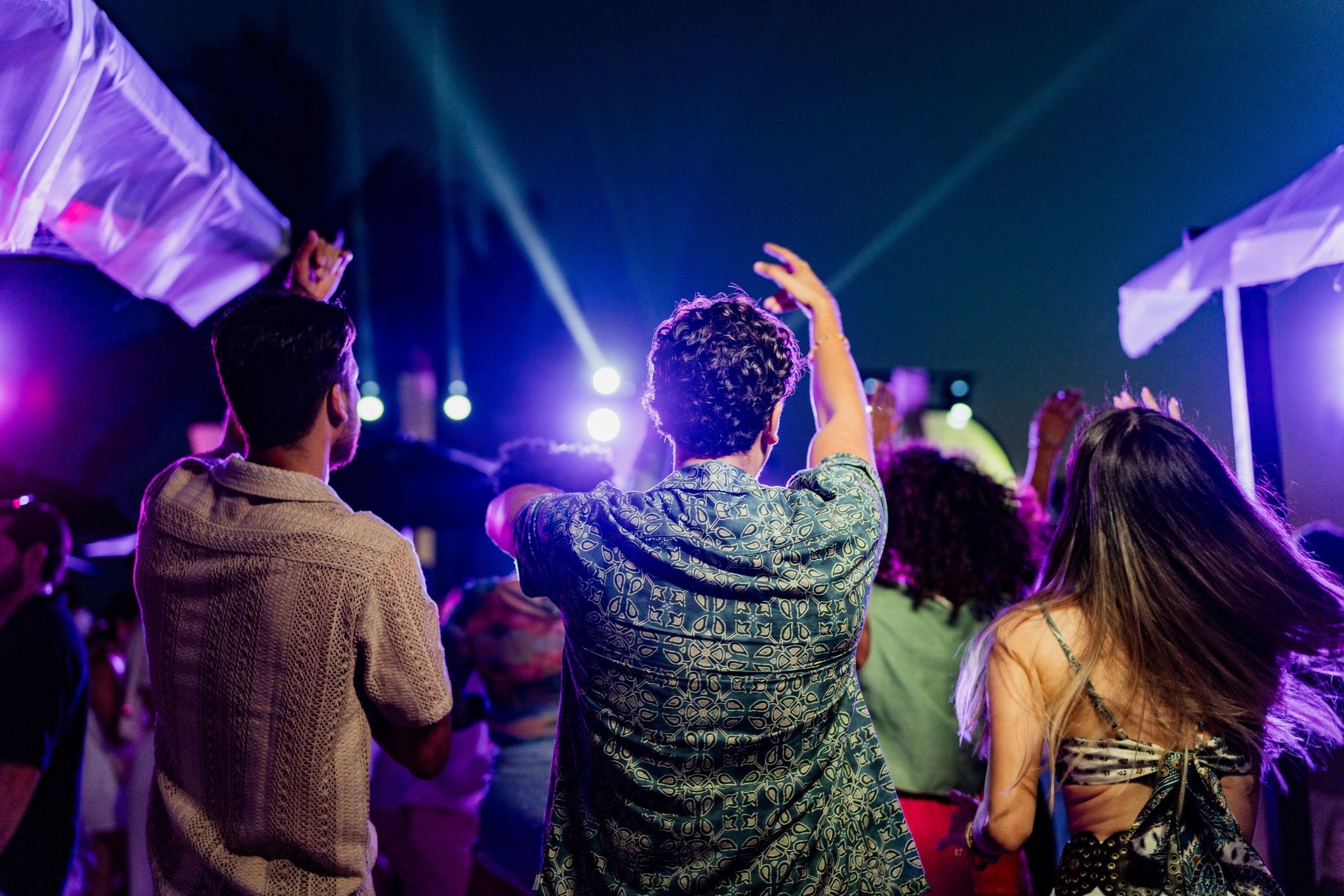 Friends dancing at an outdoor celebration